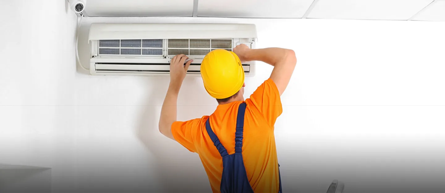 Technician servicing a split AC unit