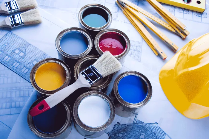 Paint cans and brushes on plans