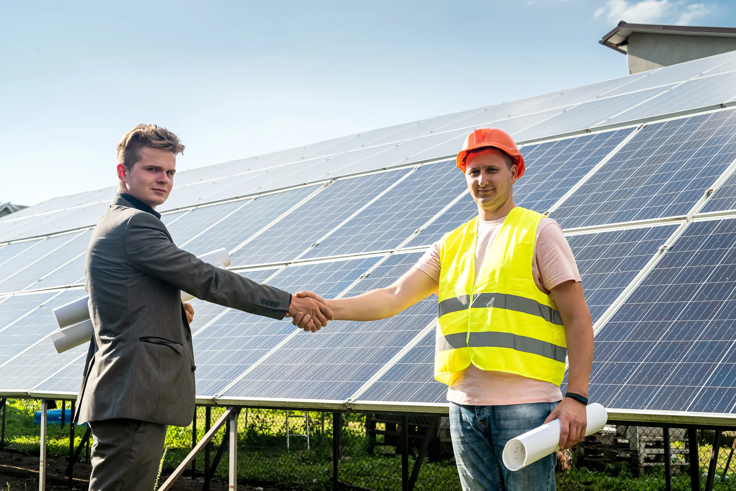 Partnership handshake at a solar site